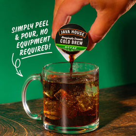 Java House peel-and-pour capsule open over ice for quick cold brew.
