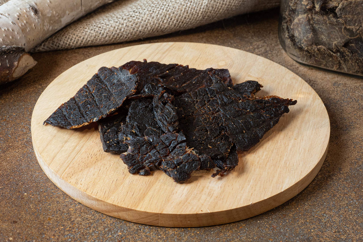 Ostrich jerky close-up texture highlighting natural quality and seasoning.