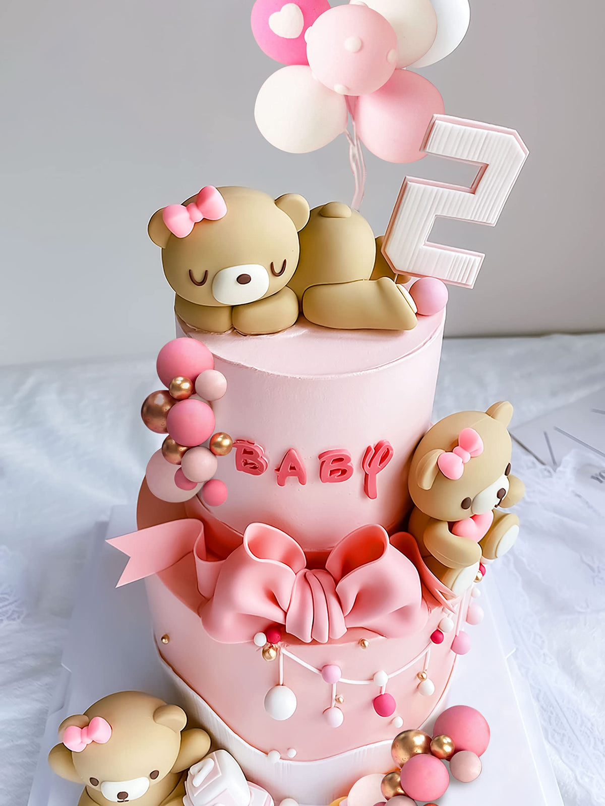 JeVenis pink balloons cake topper complements pastel teddy bear parties.