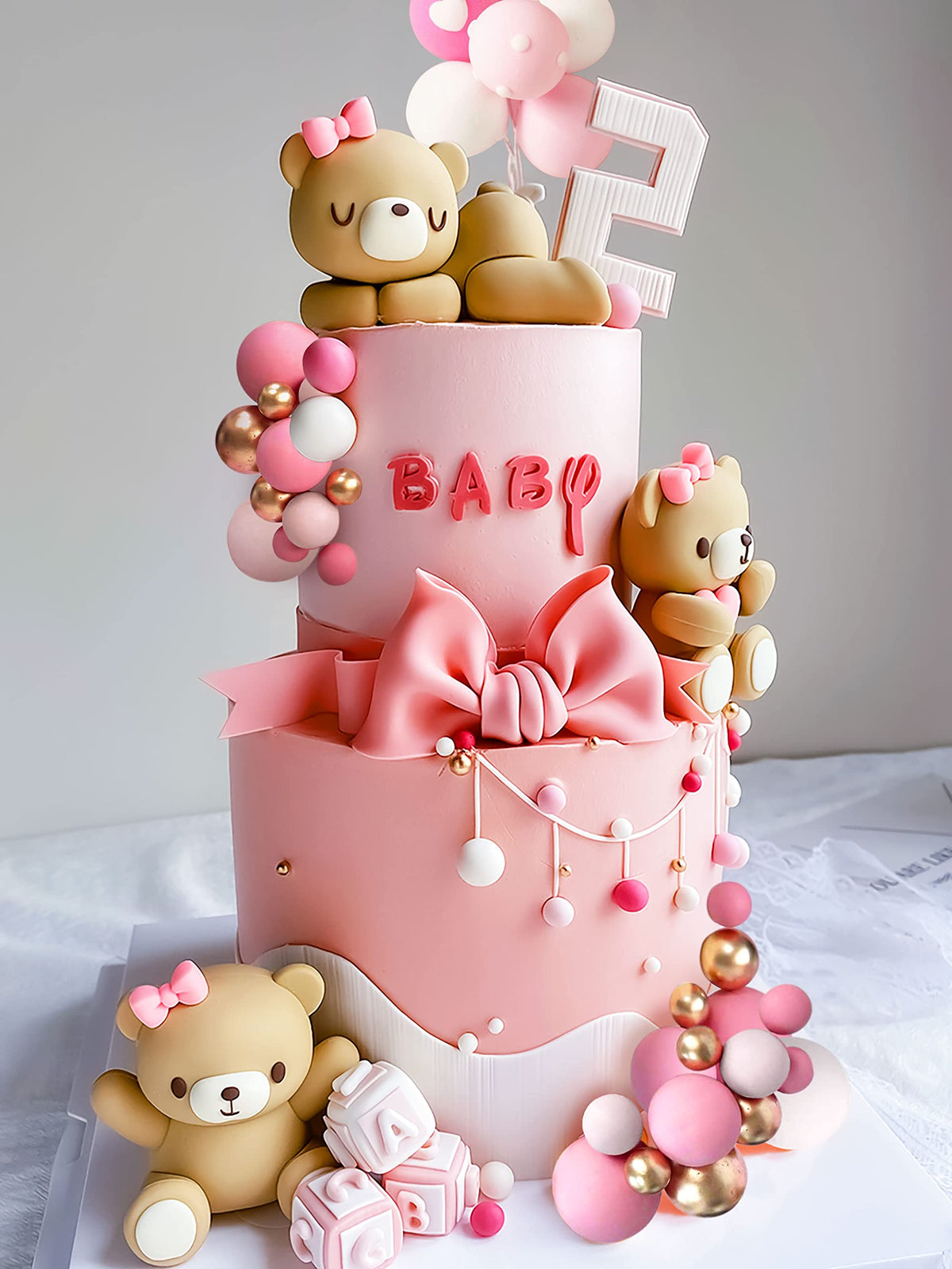 JeVenis pink balls cake decor adds soft color accents to birthday or baby showers.
