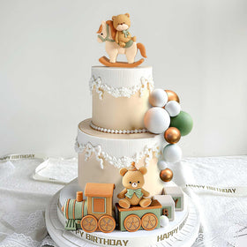 JeVenis Sage Green Train decorations complete a whimsical cake scene