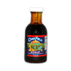 Pouring JFS Grocery Cane Field Syrup to top pancakes and desserts.