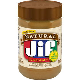 Jif Natural Creamy Peanut Butter 28oz jar close-up shows smooth spreading texture.