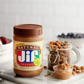 Jif Natural Creamy Peanut Butter jar pour demonstrates easy, quick spreads.