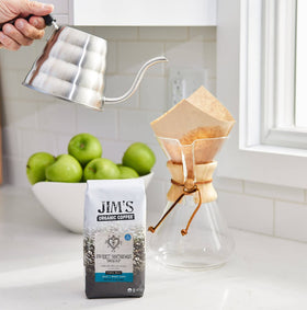 Jim's Organic Coffee Sweet Nothings Decaf kettle-pour setup highlights light roast potential.