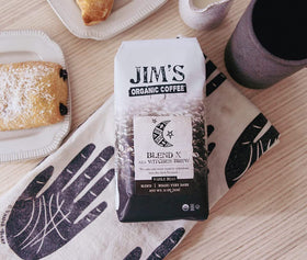 Jim's Organic Coffee Blend X steaming cup invites deep aroma