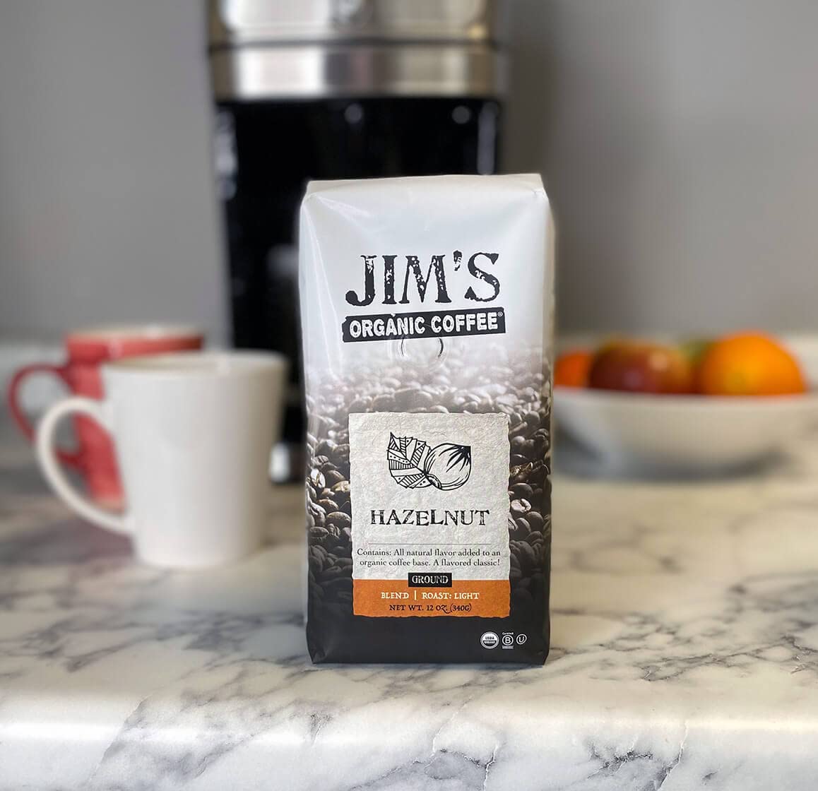 Jim's Organic Coffee hazelnut steaming cup showing aroma and warmth
