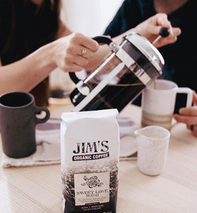 Jim's Organic Coffee Sweet Love Blend brewed cup highlighting smoky aroma.