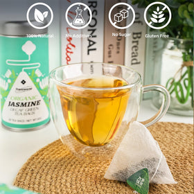 Jiuyu decaf jasmine closeup reveals real jasmine flowers infused in green tea.