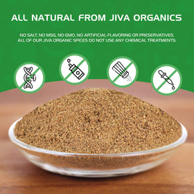 Jiva Organics ground cumin powder poured into spoon for cooking