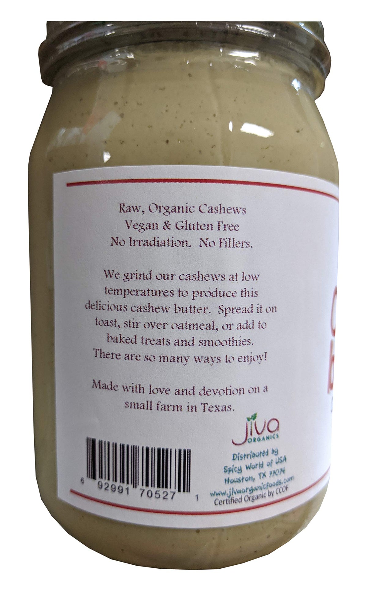Spoon with Jiva Organics RAW cashew butter shows rich creaminess perfect for bowls or toast.