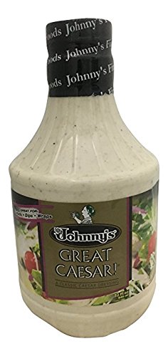 Johnny's Great Caesar dressing bottle ready to pour on a crisp salad.