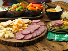 Johnsonville Summer Sausage slices on a cheese board for entertaining guests.