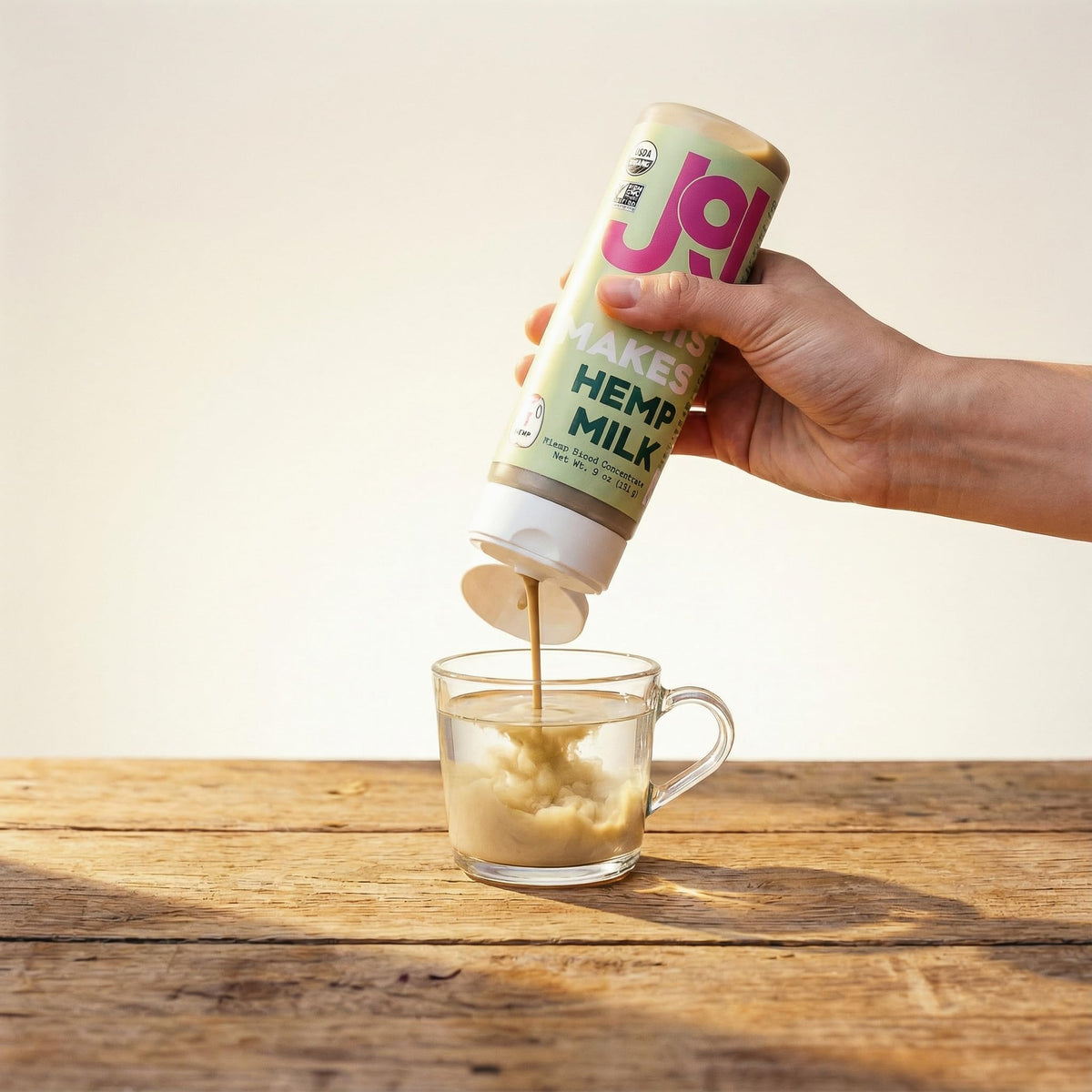 Pouring JOI hemp milk base for creamy plant-based milk.