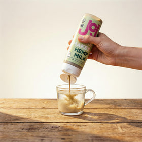 Pouring JOI hemp milk base for creamy plant-based milk.