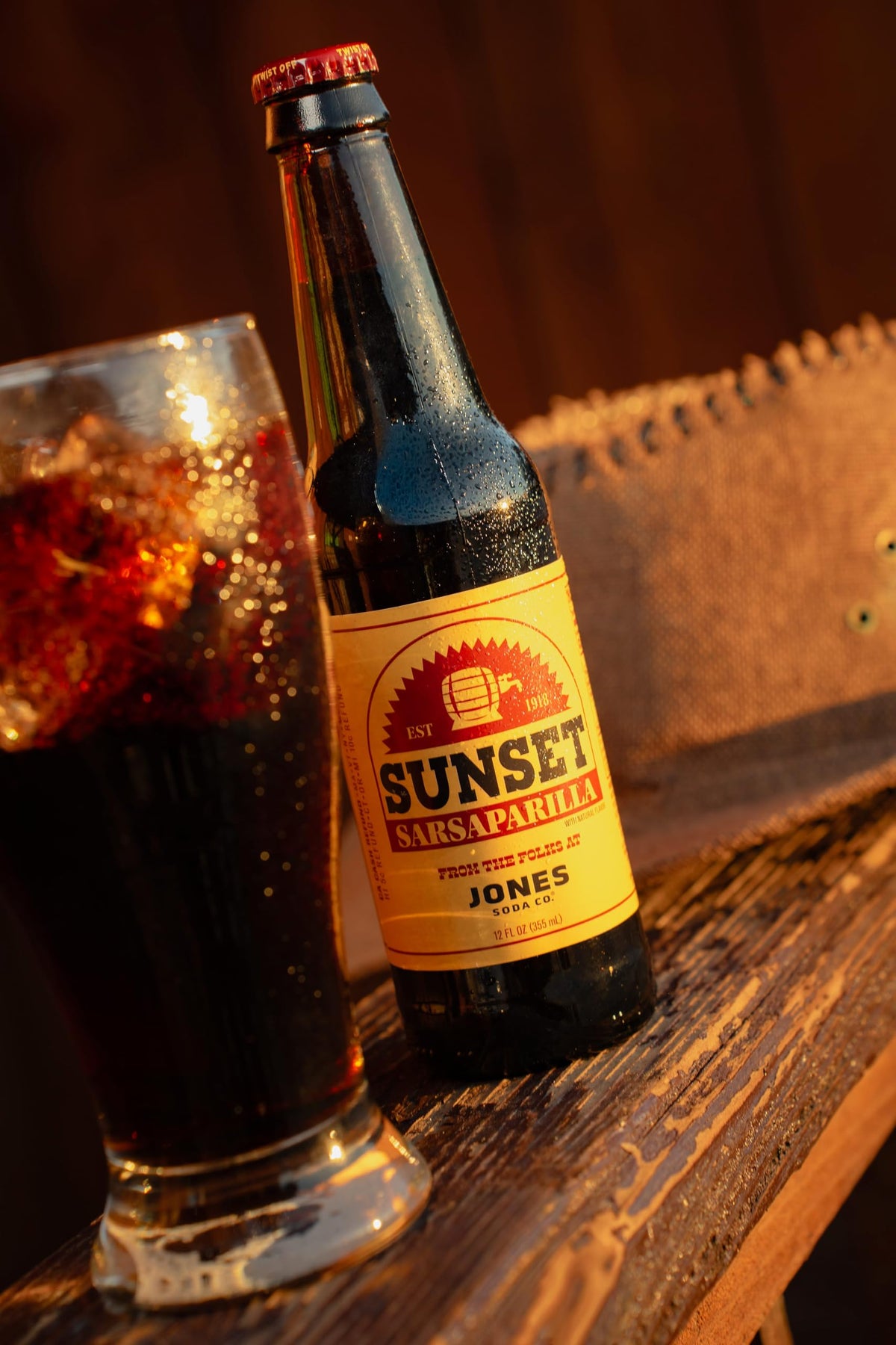 Jones Soda Fallout Sunset Sarsaparilla bottle at casual gathering.