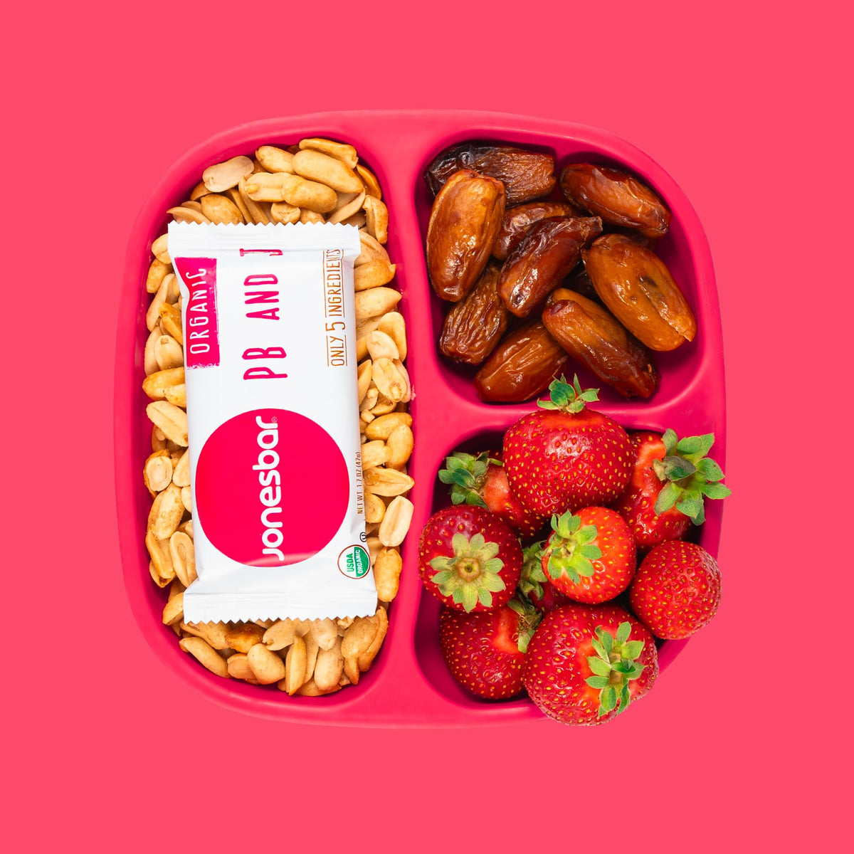 Jonesbar organic peanuts, almonds, strawberries close-up.