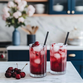 Glass with Jordan's Skinny Mixes Cherry Cola Syrup over ice