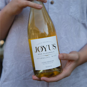 Joyus glass with toast during celebration, featuring dry, complex flavor.