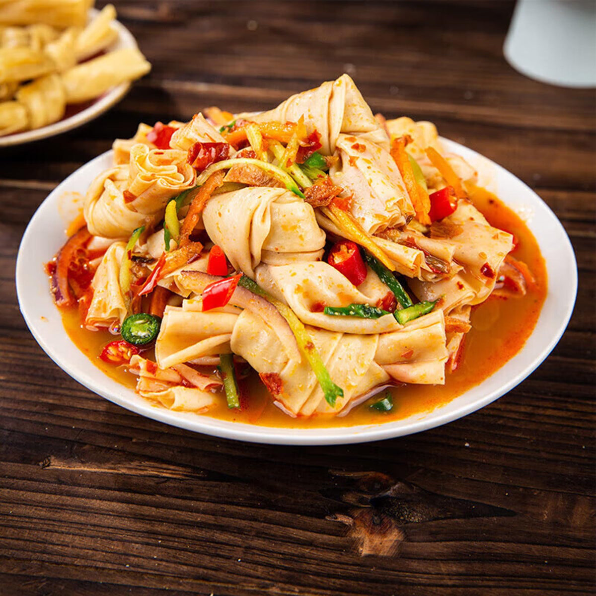 JTEDZI dried tofu skin knots simmering in a stew for added texture.