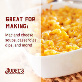 Pouring cheddar powder onto popcorn for a cheesy snack.