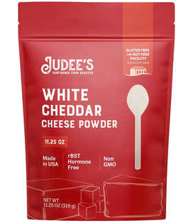 Judee's White Cheddar Cheese Powder bottle shown, ideal for rich dips and popcorn seasoning.