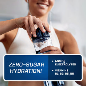 Glass with PeakH2O Berry Blue being poured for a refreshing hydration moment.