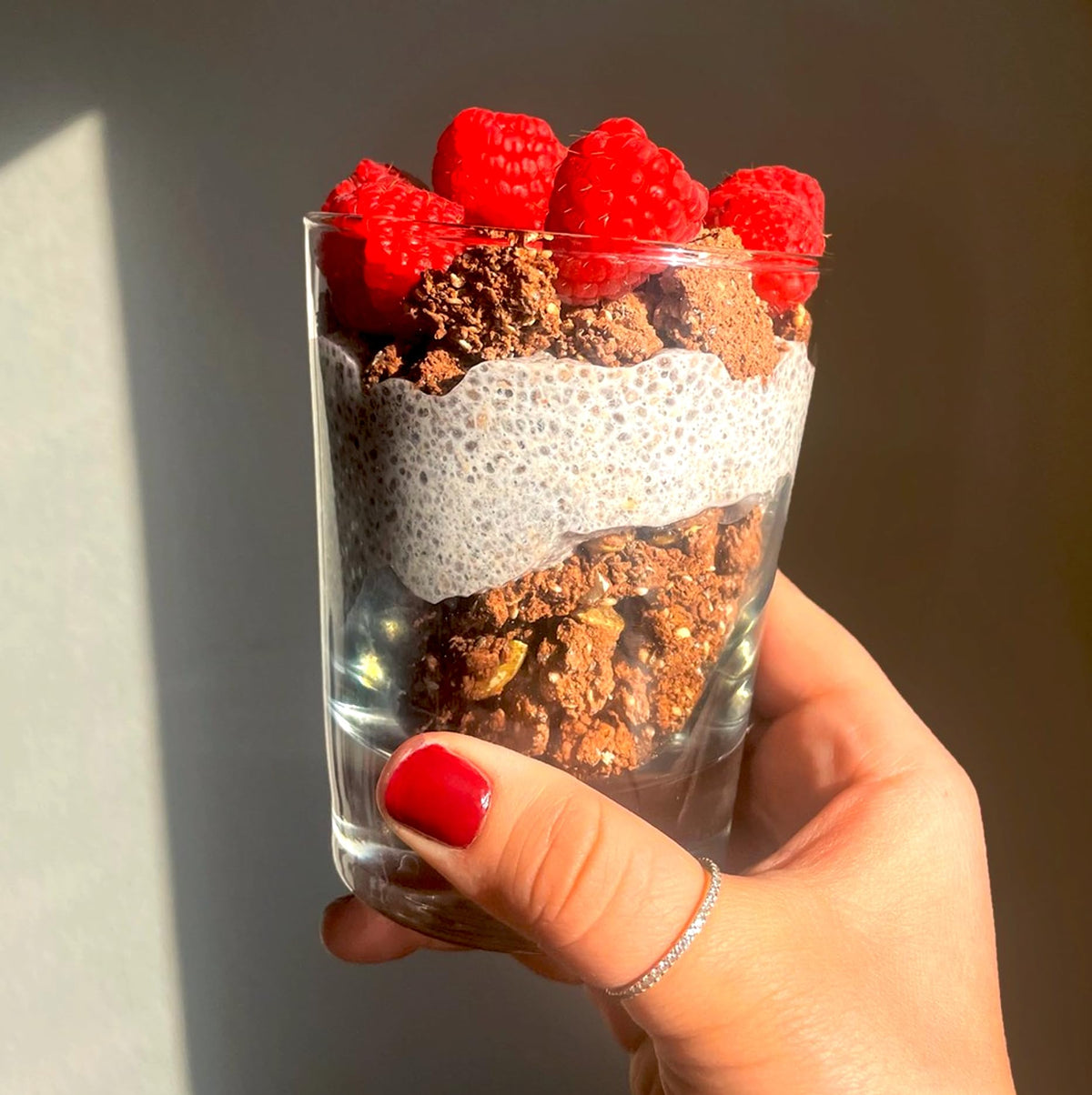 ProGranola Chocolate milk being poured beside a bowl, keto-friendly option.