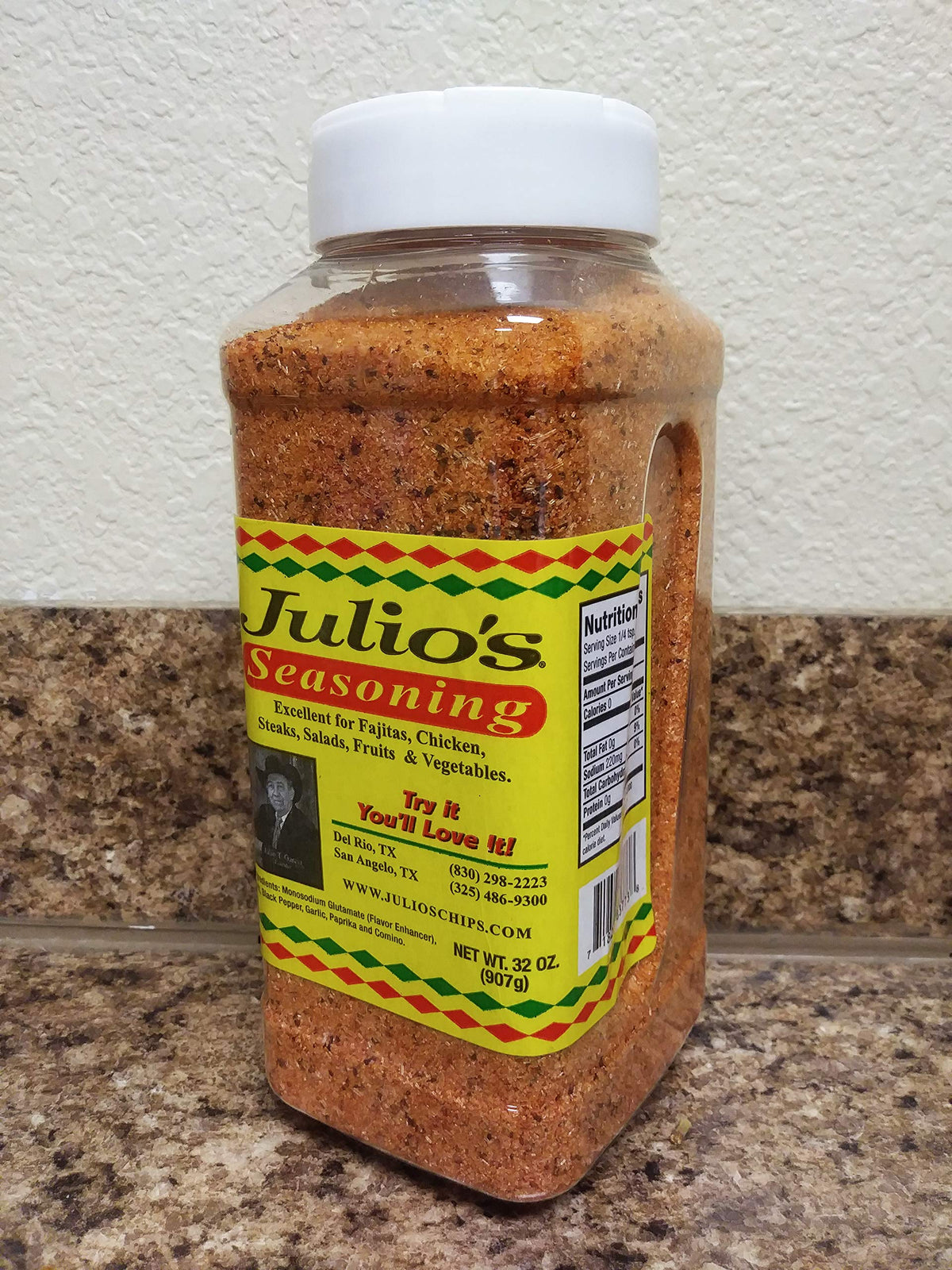 Julio's Seasoning being sprinkled on meat for enhanced flavor.