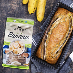 Just About Organic Banana Flour smoothie-thickener pouring into a glass for nutrition boost.