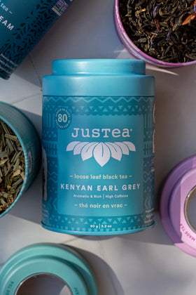 JusTea organic non-GMO certification badge on package.