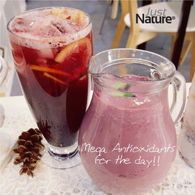 Glass of diluted JustNature Aronia juice concentrate.
