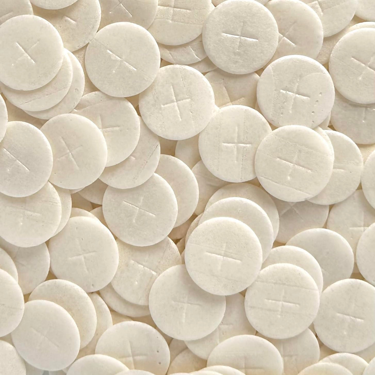 JWG Industries altar bread with 1 3/8-inch white cross design for reverent Eucharist ceremonies.
