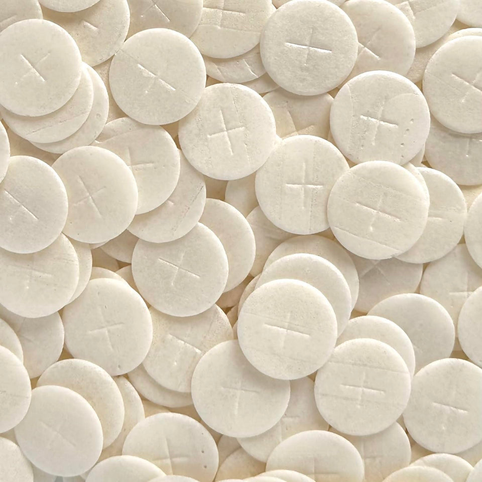 JWG Industries altar bread with 1 3/8-inch white cross design for reverent Eucharist ceremonies.