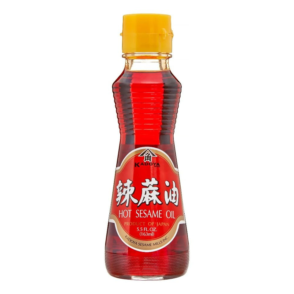 KADOYA Hot Sesame Oil bottle pouring adds chili kick to ramen and pasta.