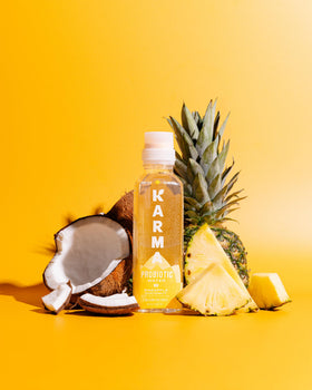 Karma Probiotic Water pineapple coconut pour suggests a quick, tasty probiotic boost