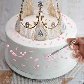Close-up of translucent pink beads and silver accents sparkling on desserts.
