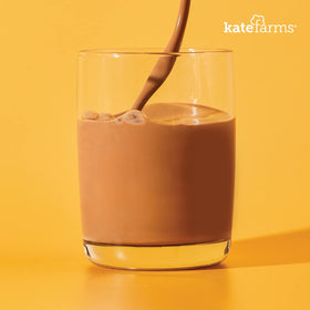 Kate Farms shake strawberry pour demonstrates convenient on the go nutrition