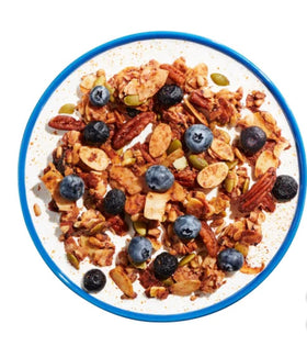 KD Chocolates NuTrael Granola served with berries and yogurt for a satisfying snack