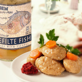 Kedem Tilapia Gefilte Fish jar ready-to-serve on a platter for entertaining