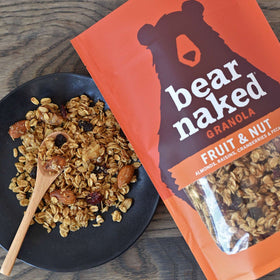 Bear Naked granola served in a bowl with yogurt and berries.