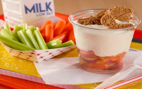 Kellogg's Cinnamon Graham Crackers Bug Bites on wooden table, inviting break time.