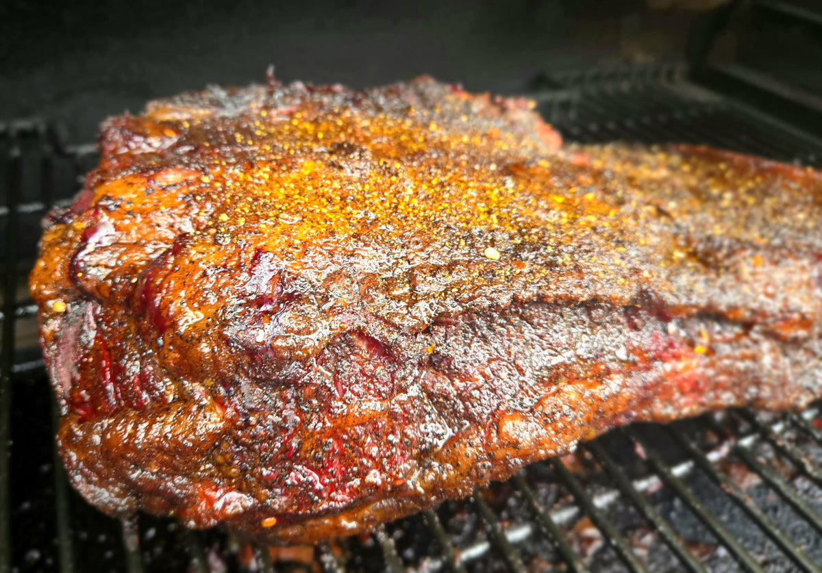 Kendu Moon Rock Rub ribs on grill with dark crust