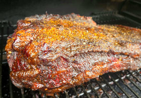 Kendu Moon Rock Rub ribs on grill with dark crust