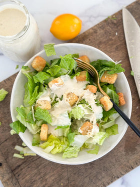Ken's Steak House Creamy Caesar Dressing pour close-up highlighting creamy texture.