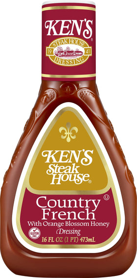 Ken's Country French Honey Dressing bottle beside a plated greens