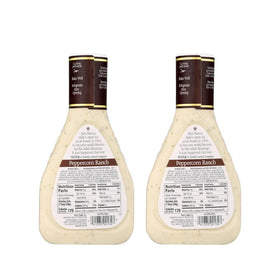 Ken's Peppercorn Ranch dressing being poured over a fresh green salad for tangy creaminess.