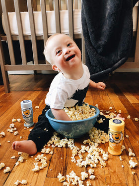 Kernel Season's Butter seasoning being poured for rich movie-night flavor.