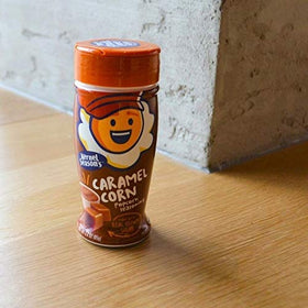 Kernel Seasons caramel popcorn seasoning jar closeup highlighting rich caramel flavor.
