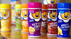 Kernel Season's Nacho Cheddar closeup texture highlights cheesy seasoning clinging to kernels.